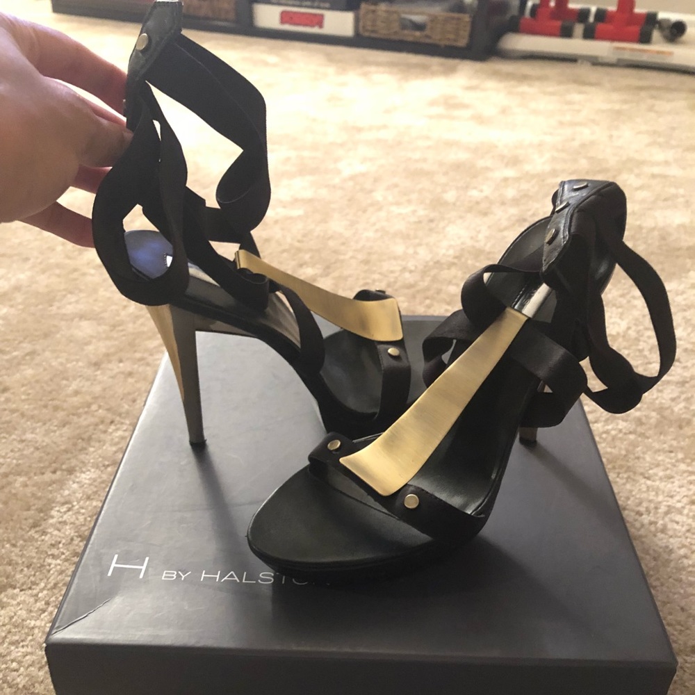 Black stiletto strappy heels with gold accent.